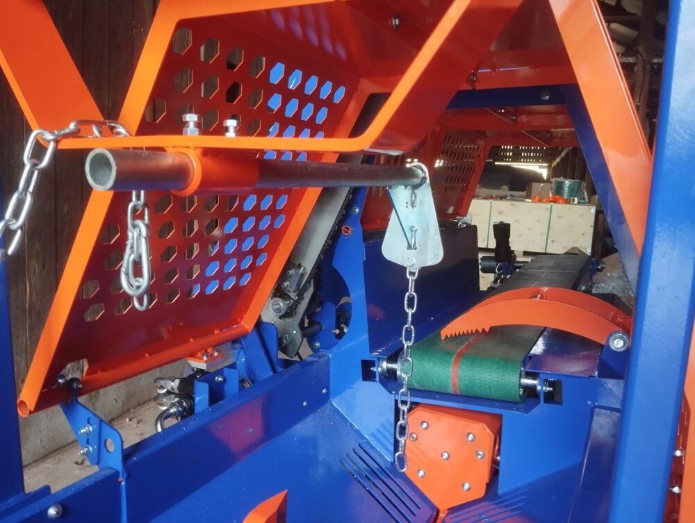 Vedmaskinens stopp där man ställer in längd på veden man klyver